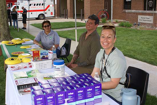 Public Health Staff seated at table at Forest View Pet Parade